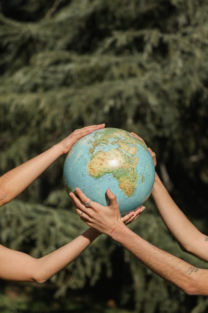 pexels-photo-6963622 People Holding a Globe